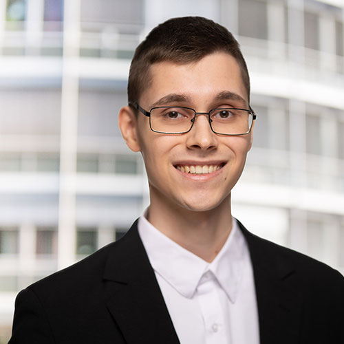 Portrait of Robin Mader, team member at HMS Analytical Software GmbH, wearing glasses and a suit jacket.
